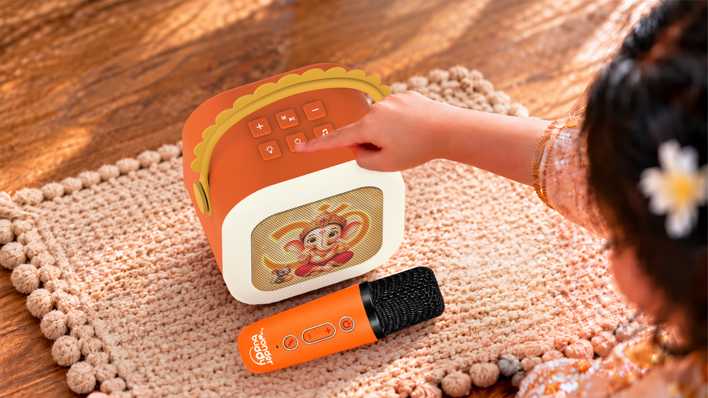 A child singing along with the Bhakti StoryBox karaoke mic